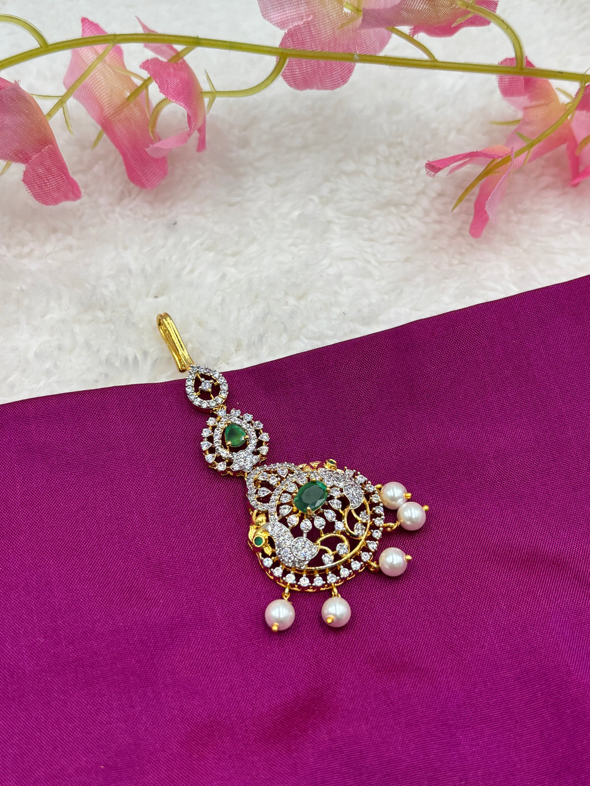 Gold Finish AD Stone Tikka with Green Center & Pearls