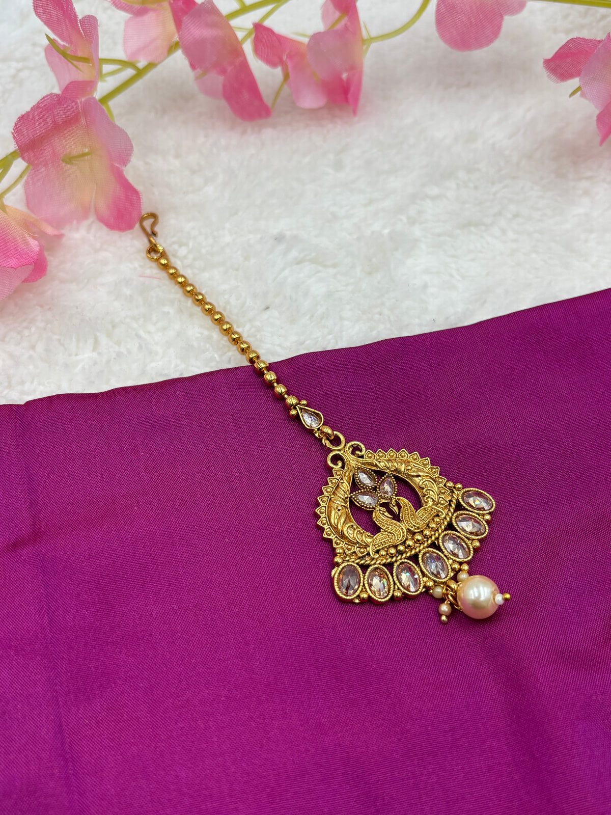 Antique Matte Gold Tikka – Peacock Motif with Crystal Stones