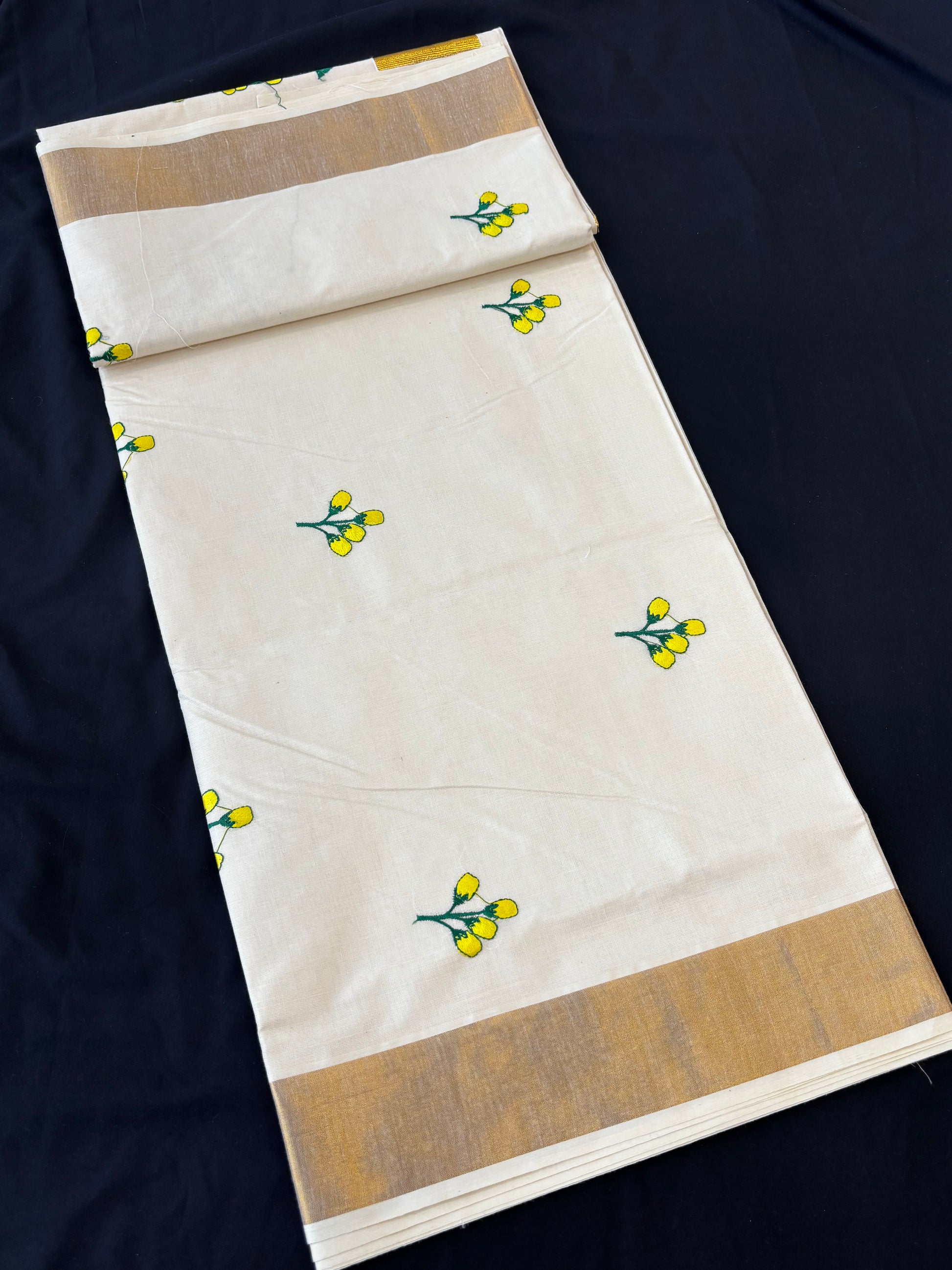 Kerala Kasavu saree with yellow floral embroidery and gold border