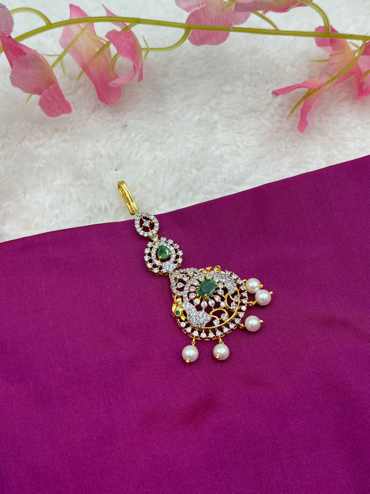 Gold Finish AD Stone Tikka with Green Center & Pearls