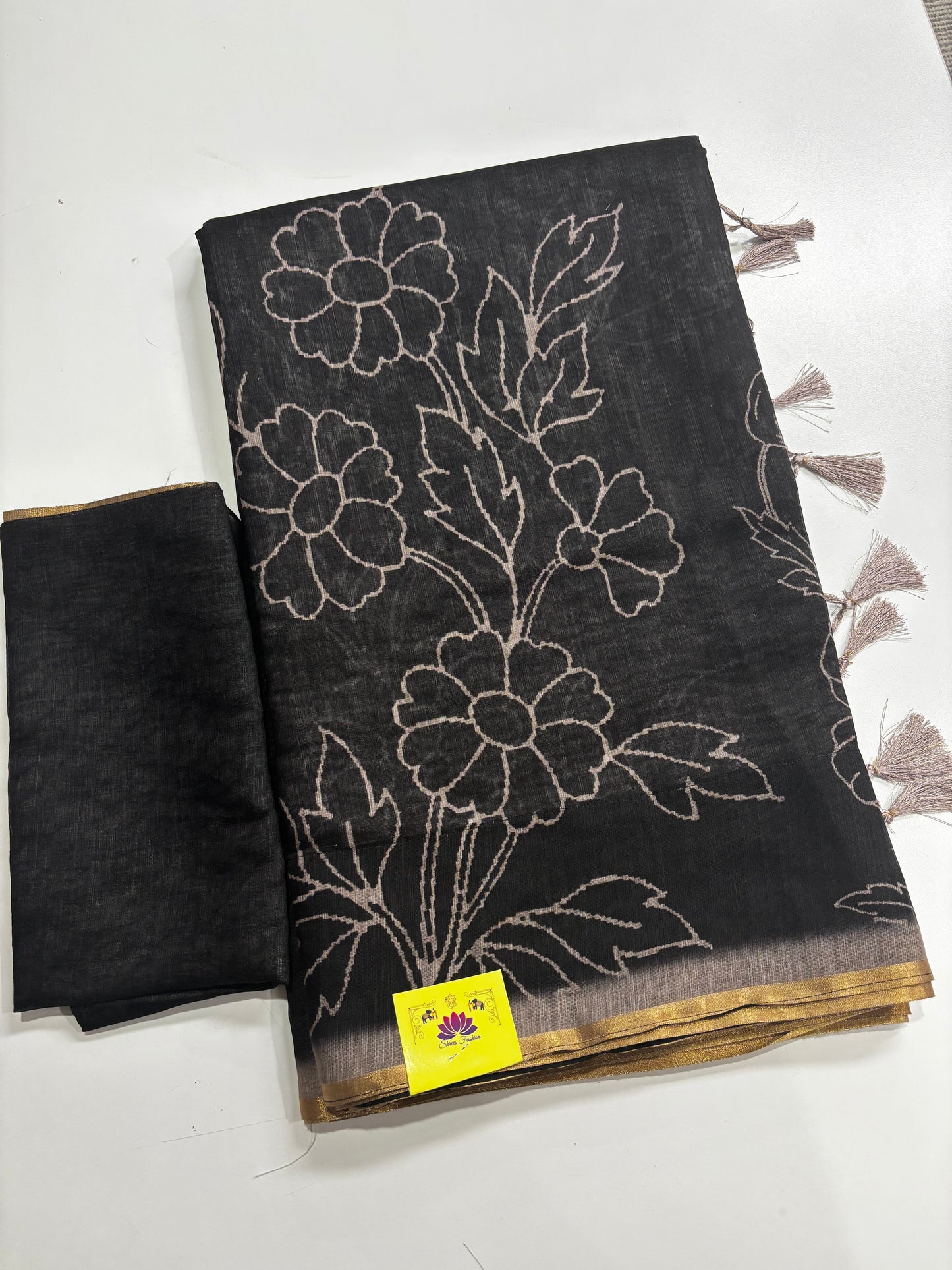 Elegantly Crafted Black Linen Cotton Saree with Beige Floral Print, Golden Border, Tassels & Blouse Piece