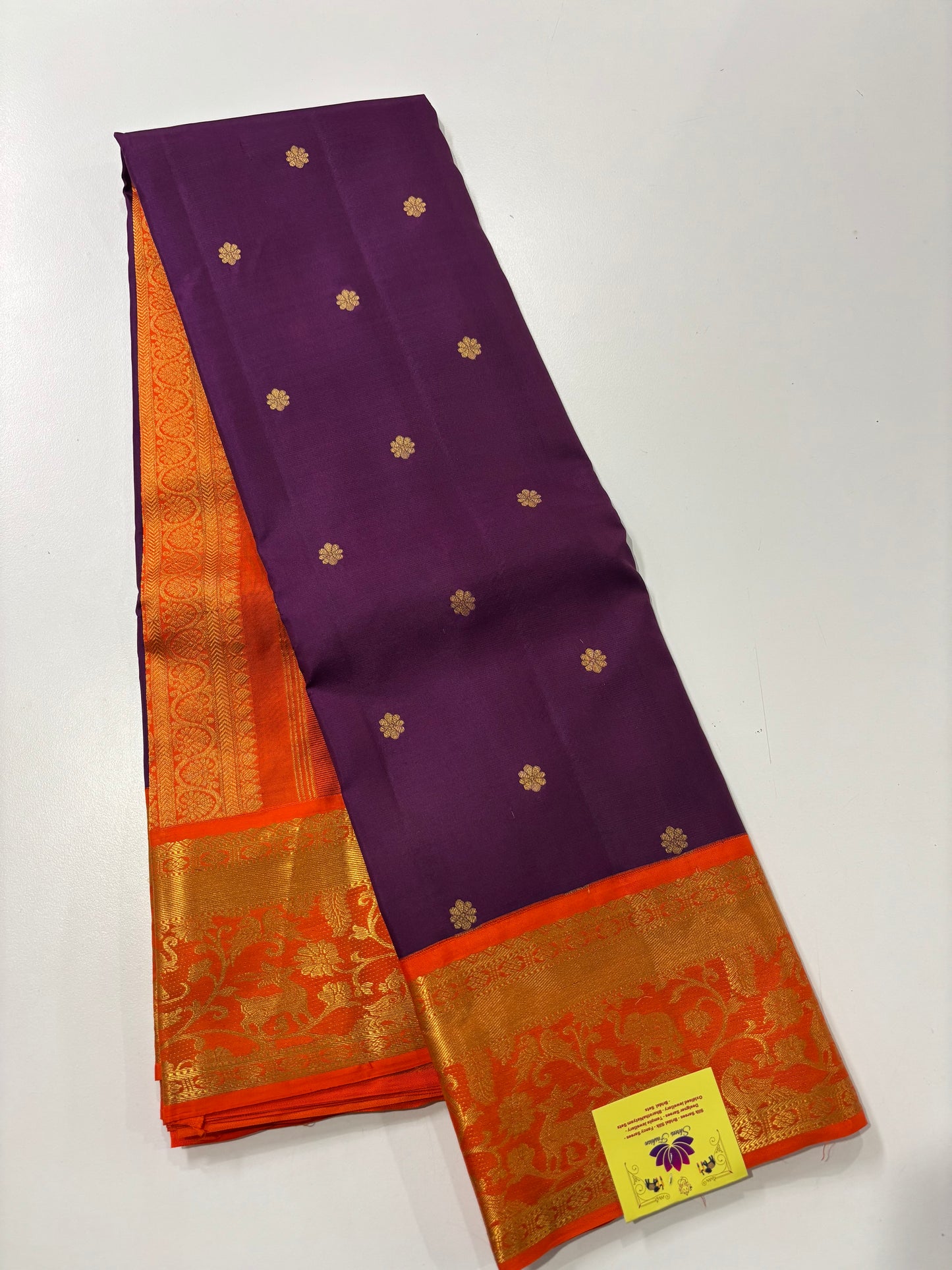 Elegant Purple Kanchipuram Silk Saree Featuring Orange Contrast and Floral Buttas