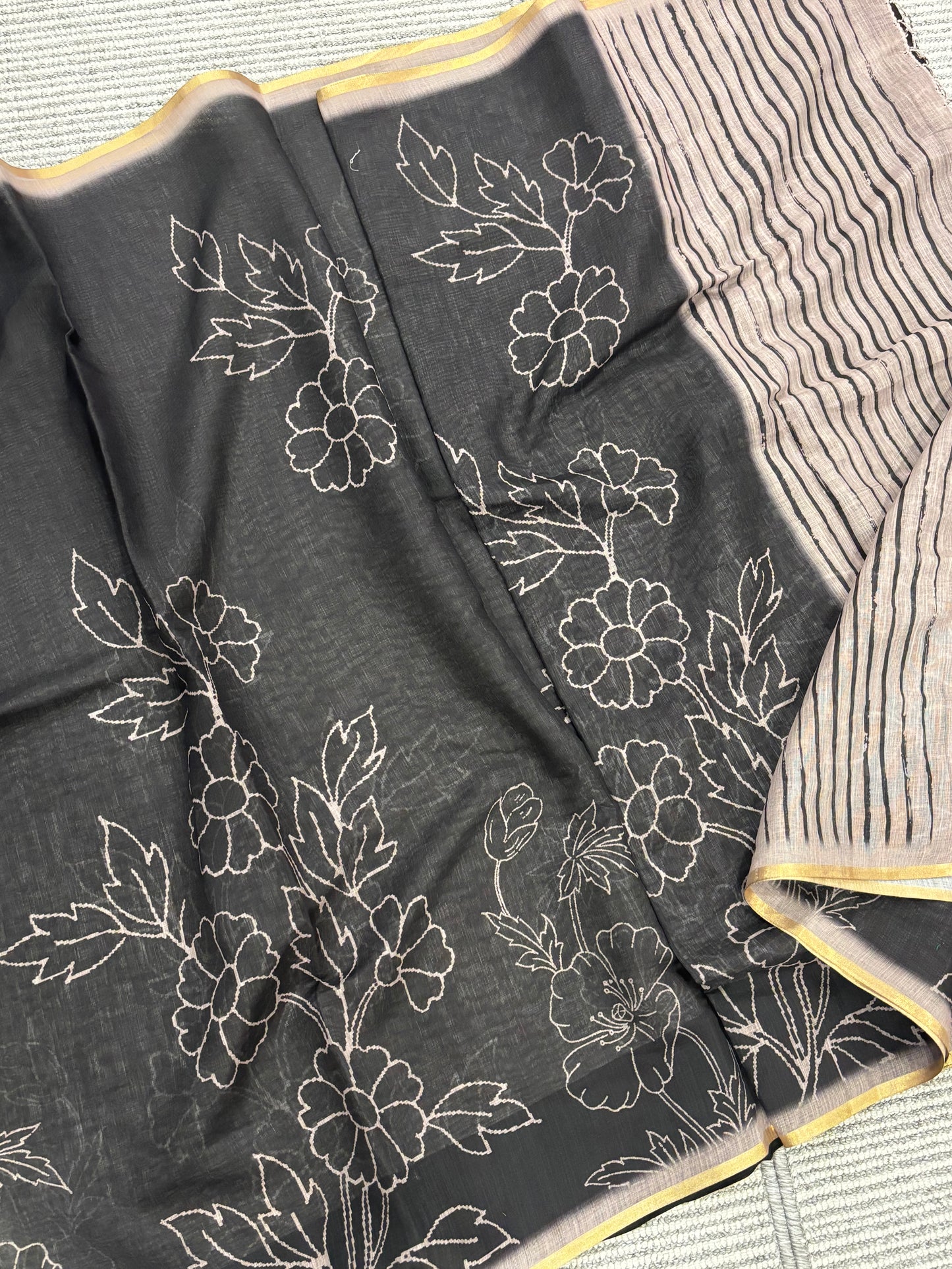 Elegantly Crafted Black Linen Cotton Saree with Beige Floral Print, Golden Border, Tassels & Blouse Piece