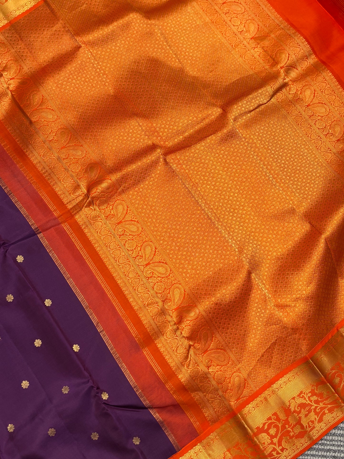 Elegant Purple Kanchipuram Silk Saree Featuring Orange Contrast and Floral Buttas