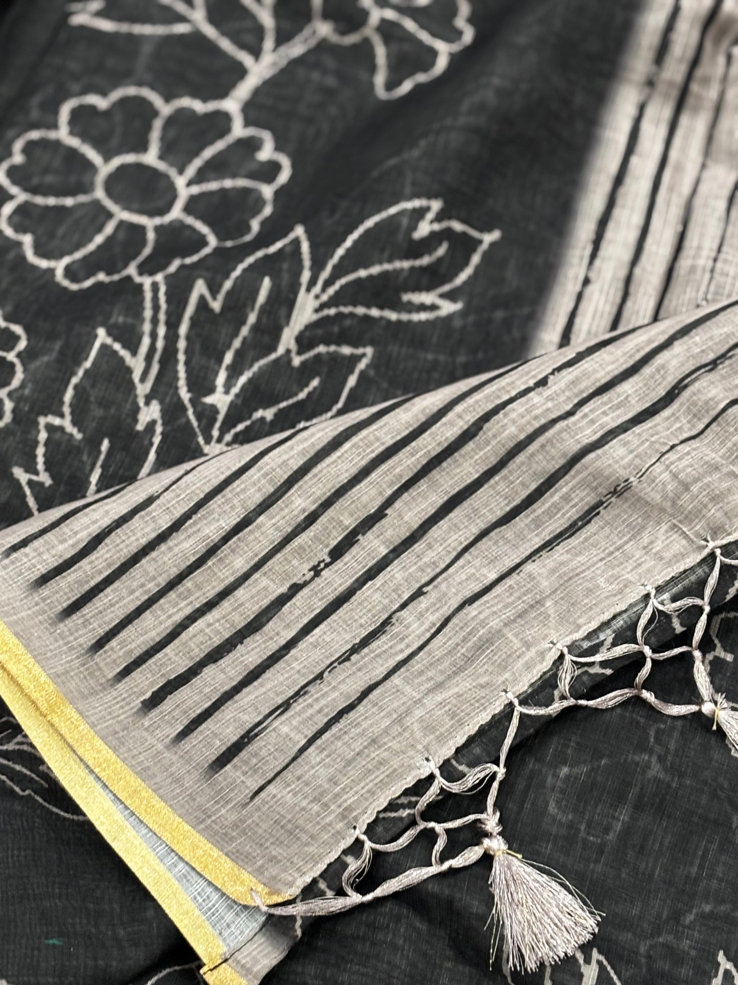 Elegantly Crafted Black Linen Cotton Saree with Beige Floral Print, Golden Border, Tassels & Blouse Piece