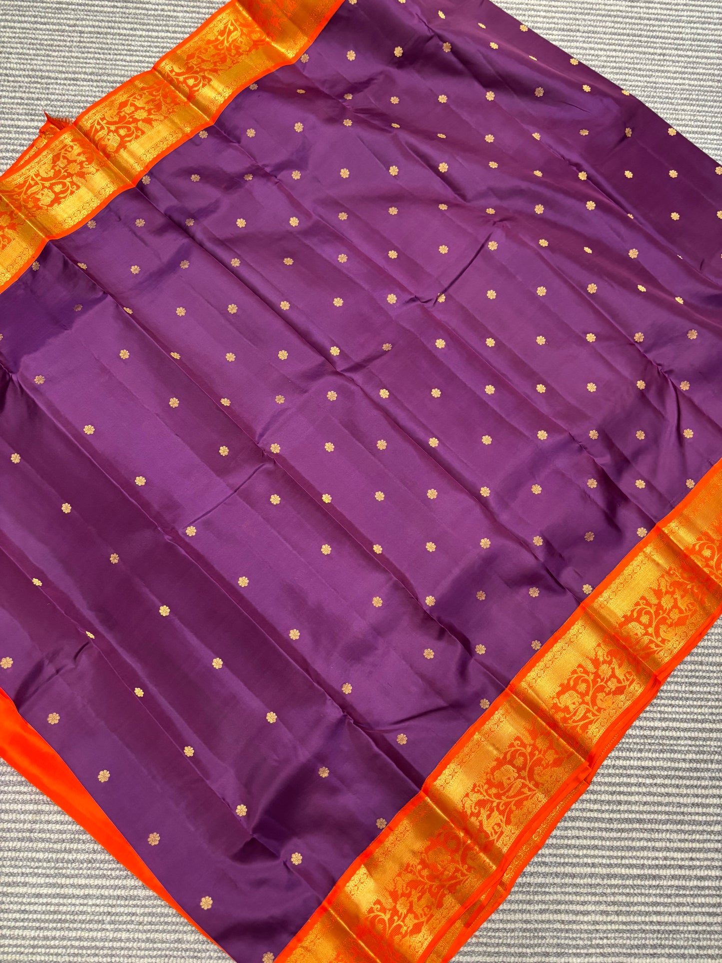 Elegant Purple Kanchipuram Silk Saree Featuring Orange Contrast and Floral Buttas