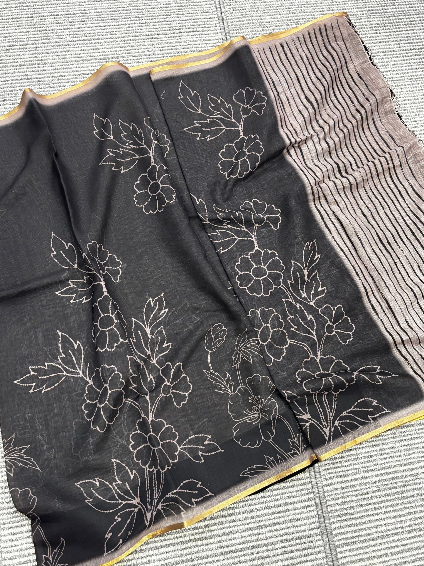 Elegantly Crafted Black Linen Cotton Saree with Beige Floral Print, Golden Border, Tassels & Blouse Piece