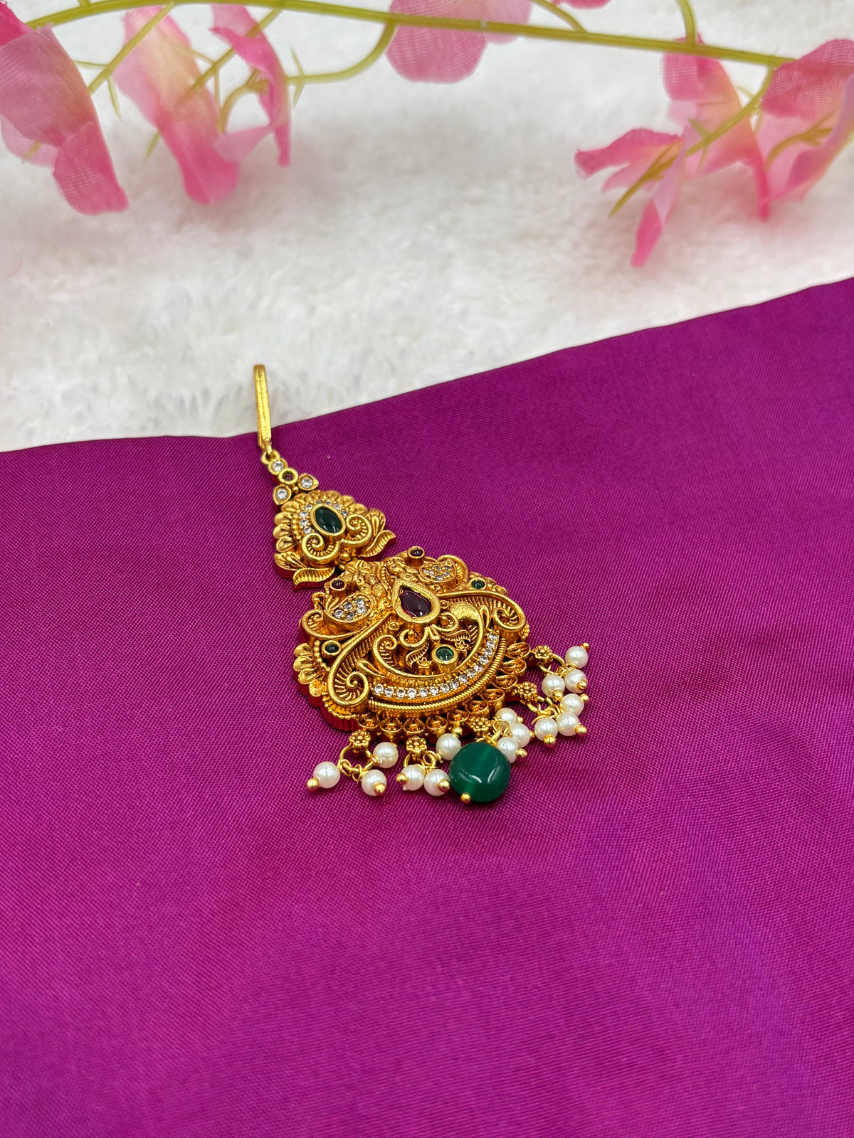 Elegant Gold Finish Tikka – Peacock Pattern with Pink Stones