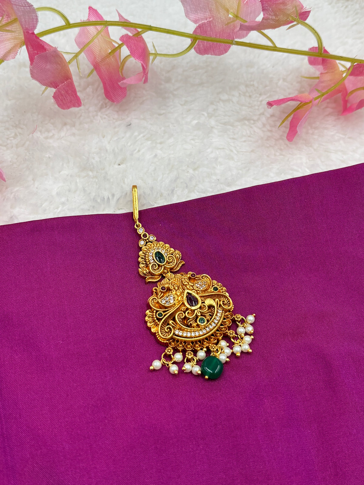 Elegant Gold Finish Tikka – Peacock Pattern with Pink Stones
