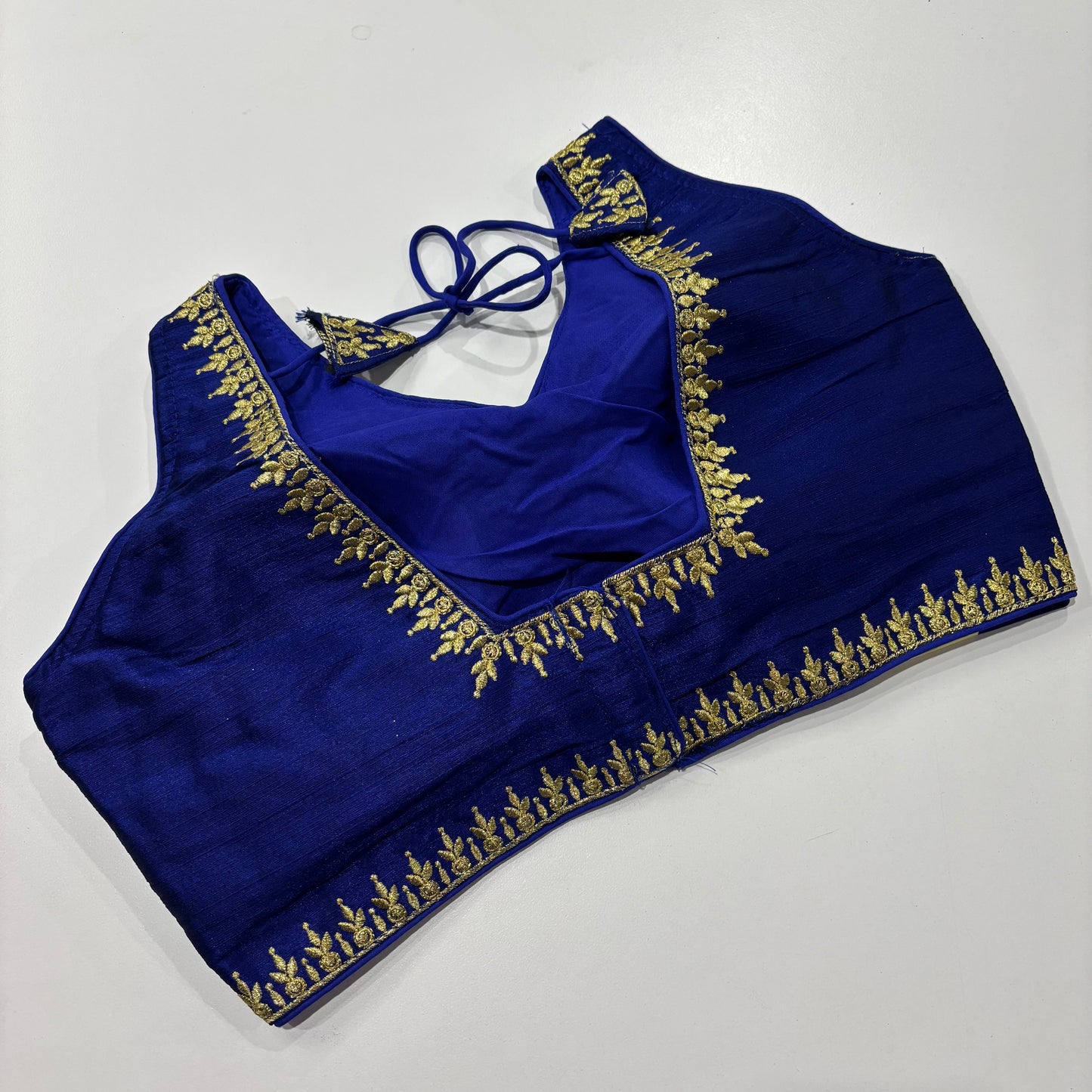 Royal Blue Sleeveless Blouse – Golden Embroidery & Draped Sleeve Detail
